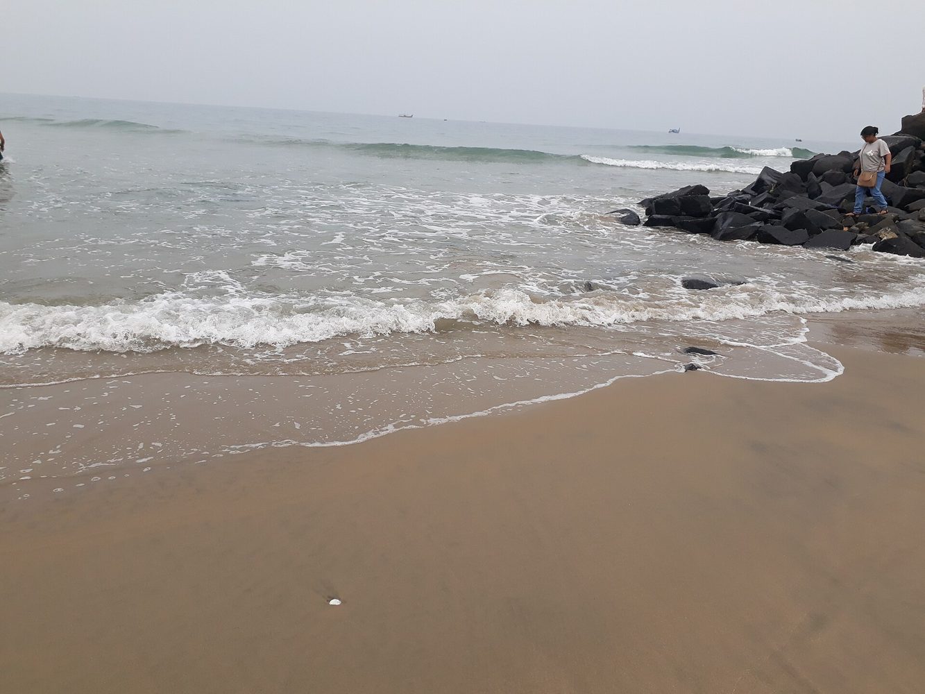 Waves meeting the sandy shoreline at Serenity Beach near Pondicherry