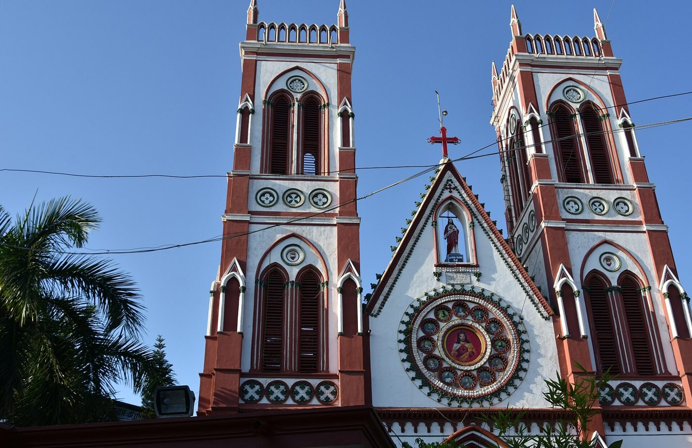 Red and white Gothic Revival facade of the Basilica of the Sacred Heart of Jesus, Pondicherry