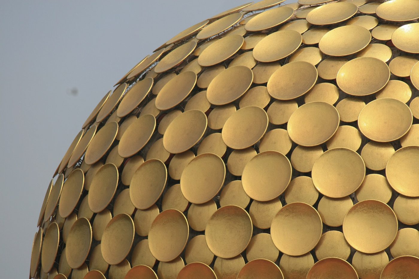Golden spherical Matrimandir surrounded by gardens in Auroville